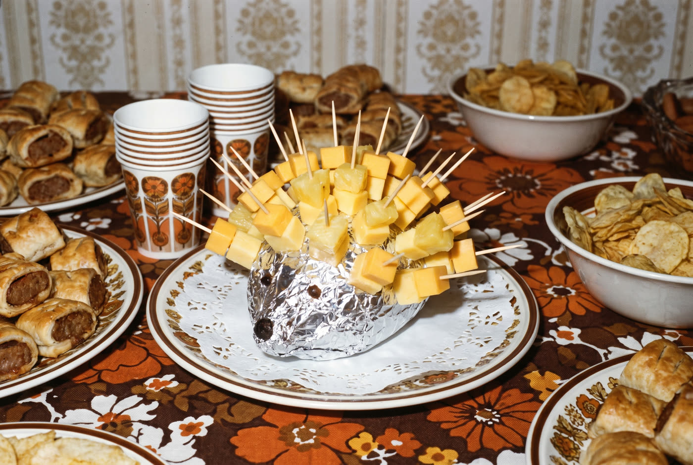 Cheese and pineapple on sticks, jabbed into a foil-covered potato